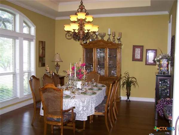 a view of a dining room with furniture and chandelier