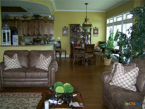 a living room with furniture and a chandelier