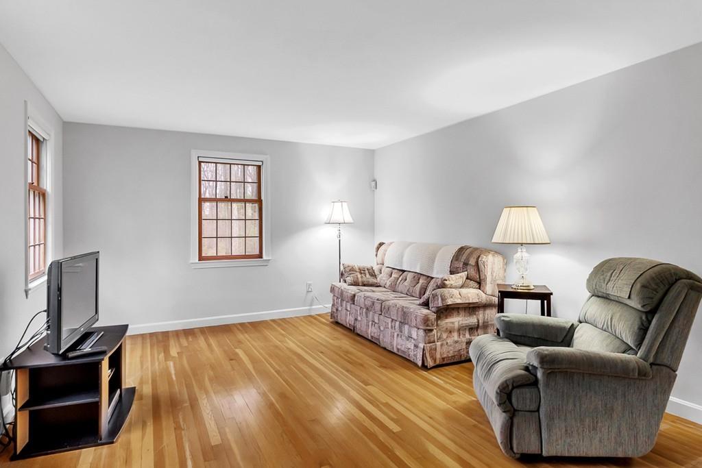 4 Canter Road Chelmsford, MA 01824 - Photo 8 of 35 a living room with couches and a flat screen tv with kitchen view