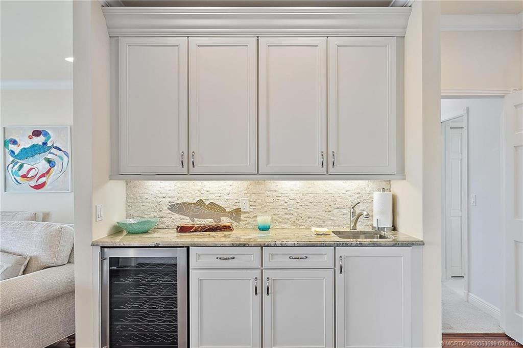 4105 Rigels Cove Way Jensen Beach, FL 34957 - Photo 33 of 80 a bathroom with a granite countertop sink and a white cabinets