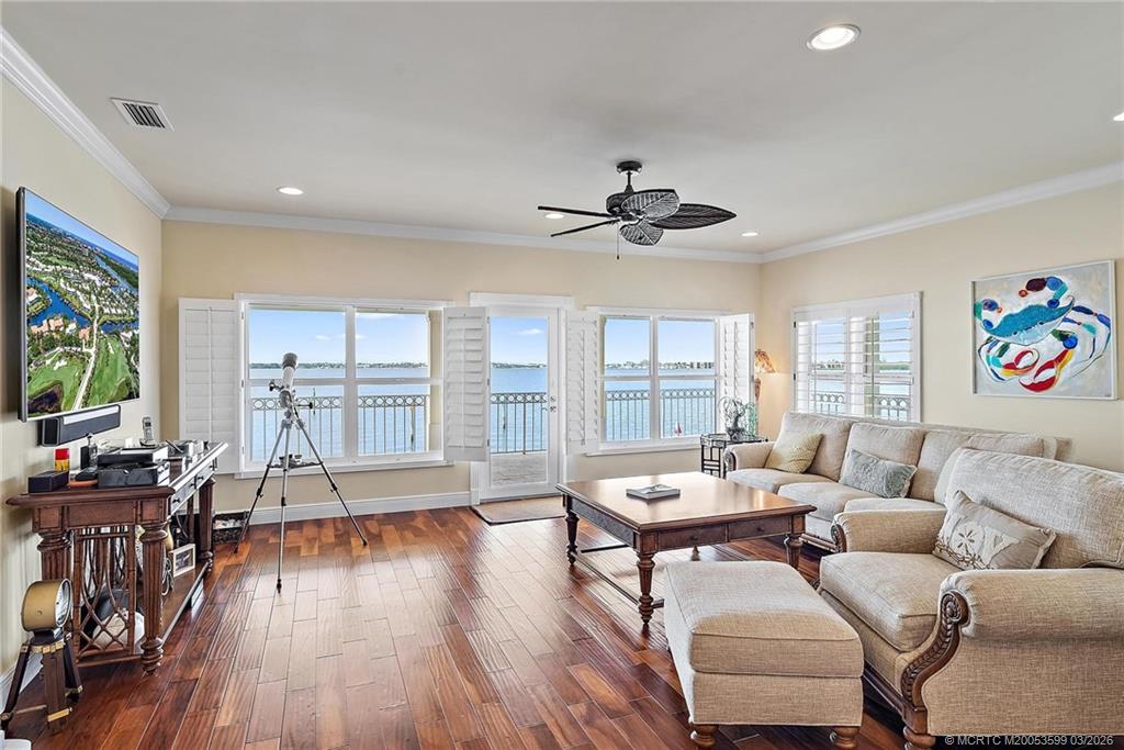 4105 Rigels Cove Way Jensen Beach, FL 34957 - Photo 35 of 80 a living room with furniture and a flat screen tv with wooden floor