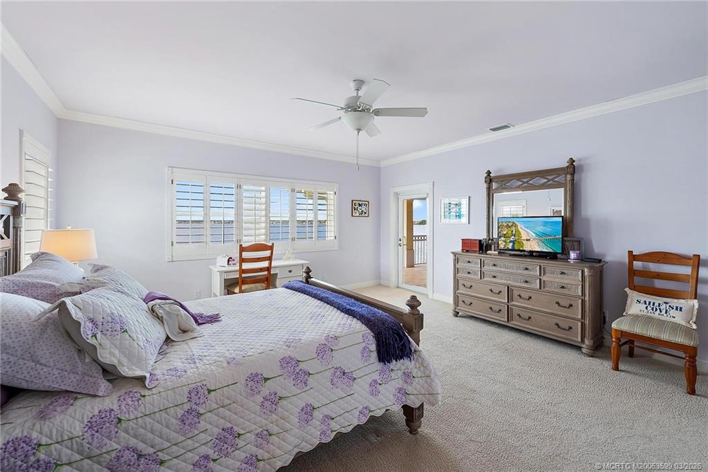 4105 Rigels Cove Way Jensen Beach, FL 34957 - Photo 39 of 80 a bedroom with a bed and a chandelier