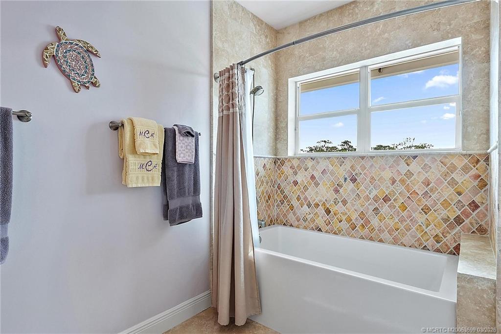 4105 Rigels Cove Way Jensen Beach, FL 34957 - Photo 41 of 80 a bathroom with a bathtub and shower