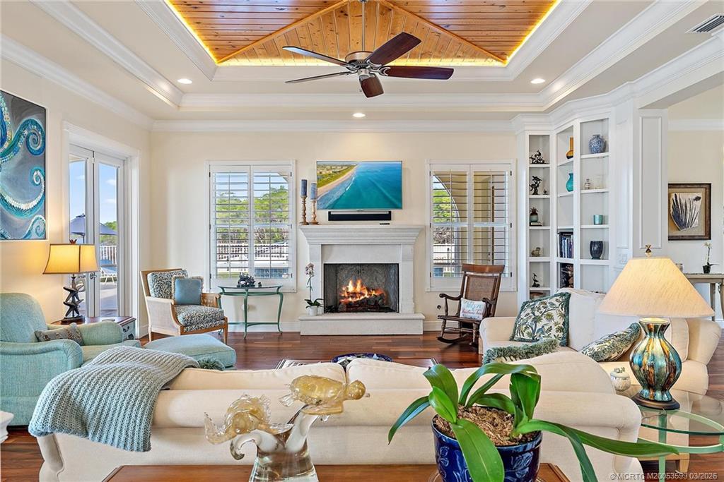 4105 Rigels Cove Way Jensen Beach, FL 34957 - Photo 79 of 80 a living room with furniture a fireplace and a flat screen tv