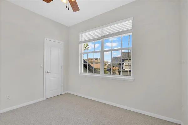 a view of a swimming pool with lawn chairs and a big yard