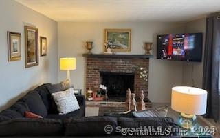 38 Timber Lane, Unit 1 Waterbury, CT 06705 - Photo 6 of 15 a living room with furniture and a fireplace