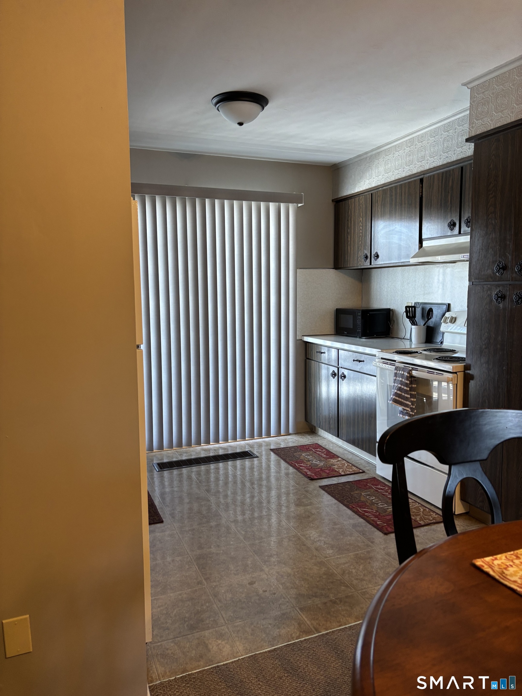 38 Timber Lane, Unit 1 Waterbury, CT 06705 - Photo 7 of 15 a hallway with a sink and a refrigerator
