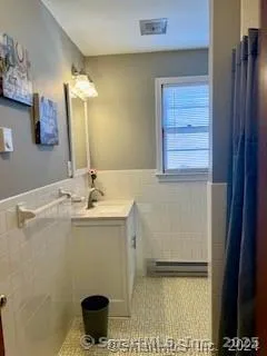 a bathroom with a sink a toilet and a mirror