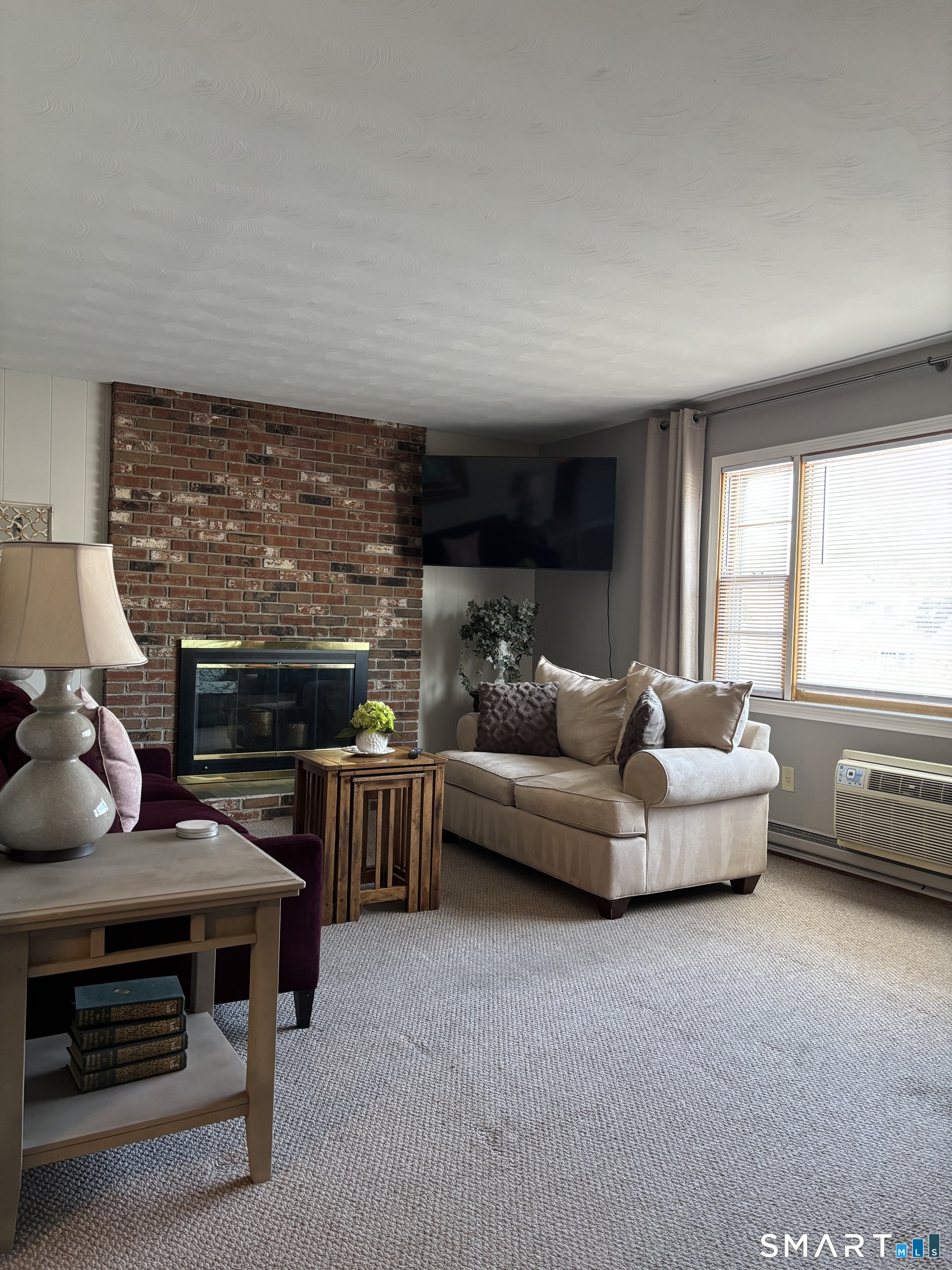 38 Timber Lane, Unit 1 Waterbury, CT 06705 - Photo 9 of 15 a living room with furniture and a fireplace