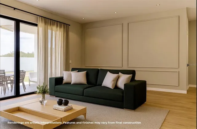 a living room with furniture and large windows