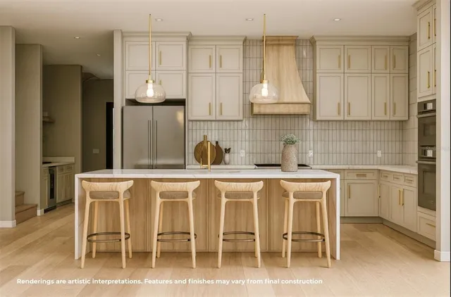 a white kitchen with cabinets and chairs