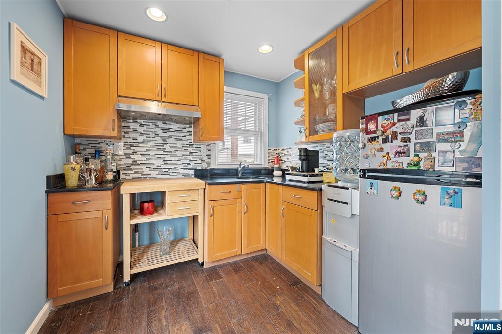 5 Leo Terrace Bloomfield, NJ 07003 - Photo 23 of 32 a kitchen with granite countertop stainless steel appliances and wooden cabinets