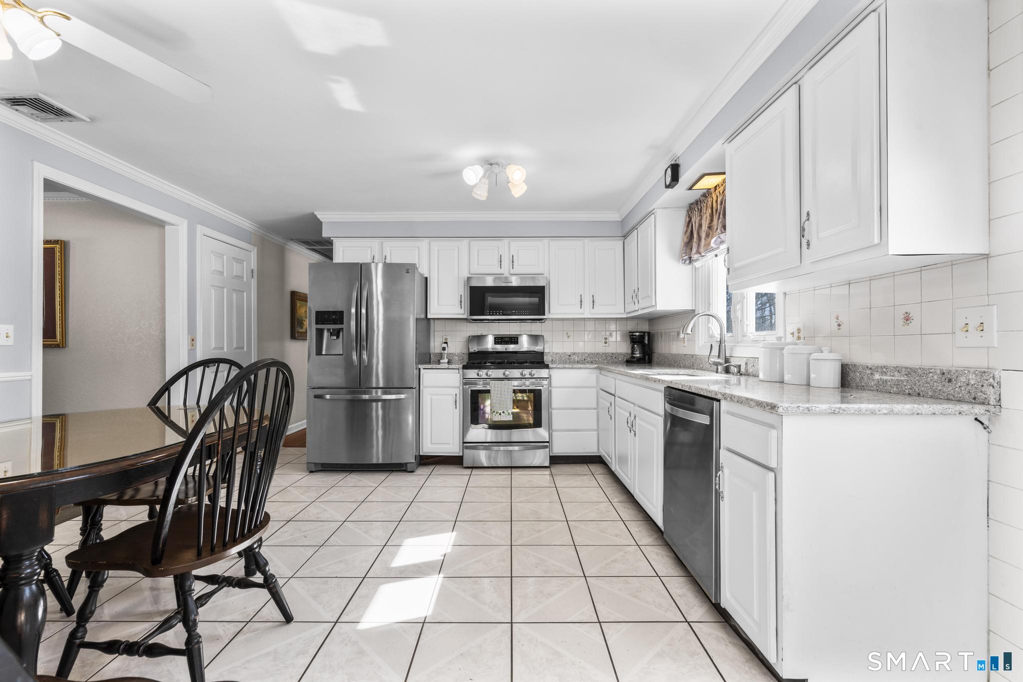 60 Quail Trail Trumbull, CT 06611 - Photo 19 of 37 a kitchen with stainless steel appliances granite countertop a stove a sink a microwave and a refrigerator
