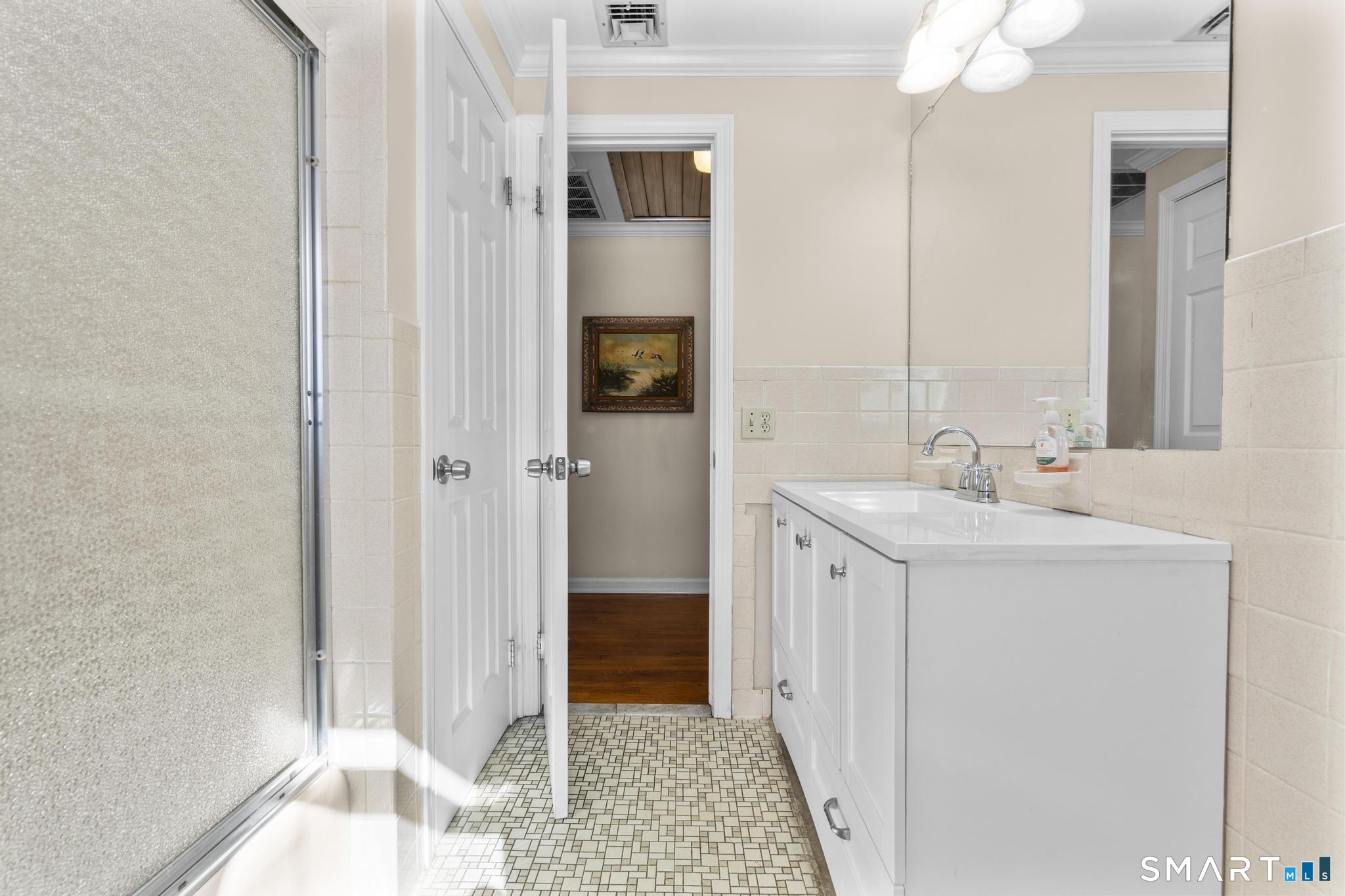 60 Quail Trail Trumbull, CT 06611 - Photo 24 of 37 a en suite bathroom with a sink a mirror and a shower