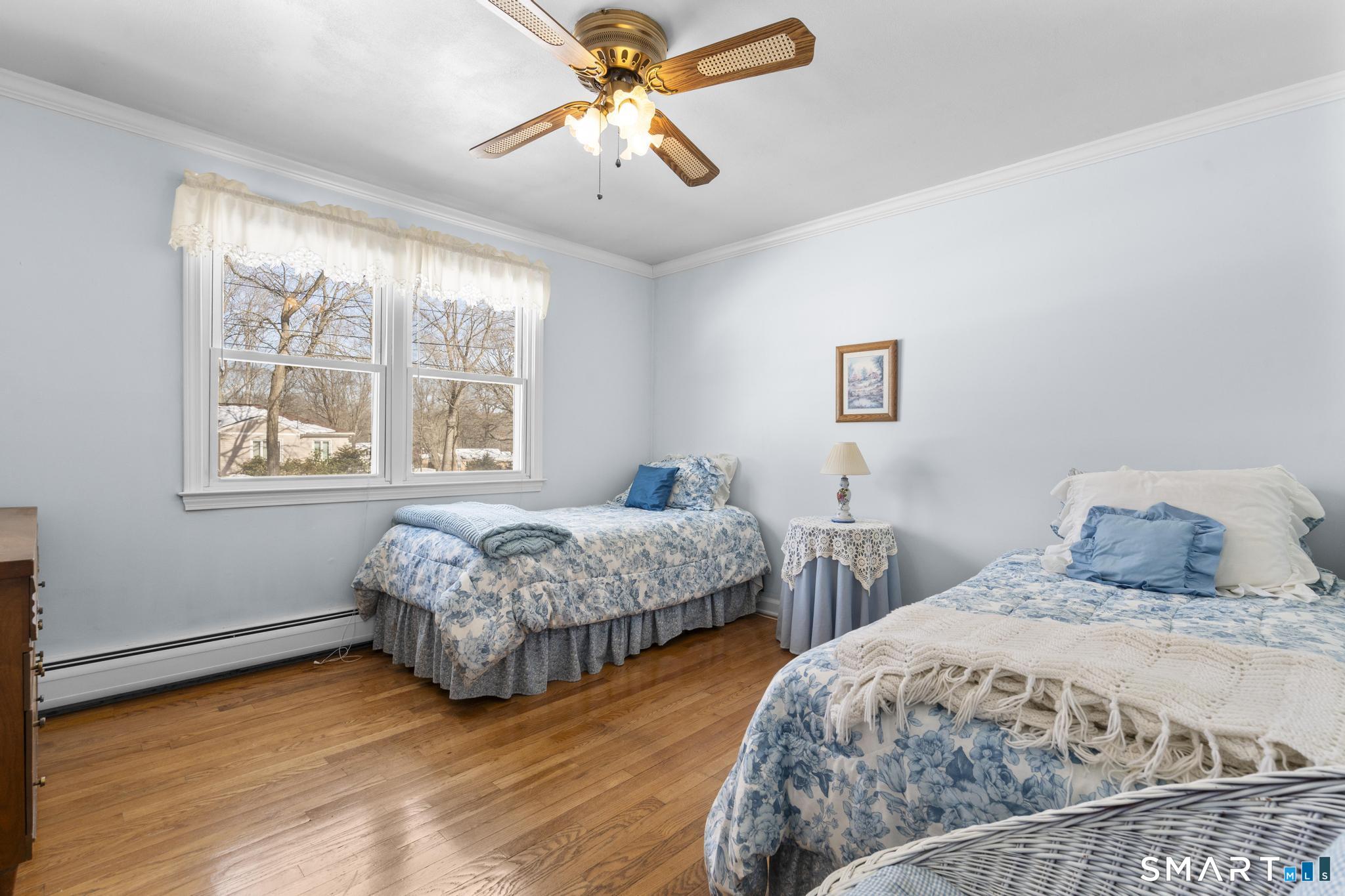 60 Quail Trail Trumbull, CT 06611 - Photo 27 of 37 a bedroom with two beds and a chandelier