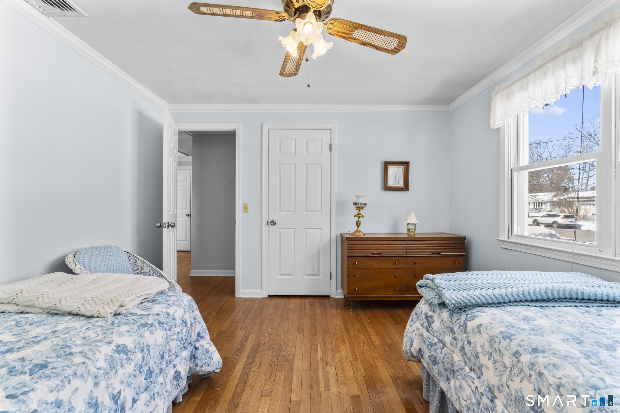 60 Quail Trail Trumbull, CT 06611 - Photo 28 of 37 a bedroom with a bed and a chandelier