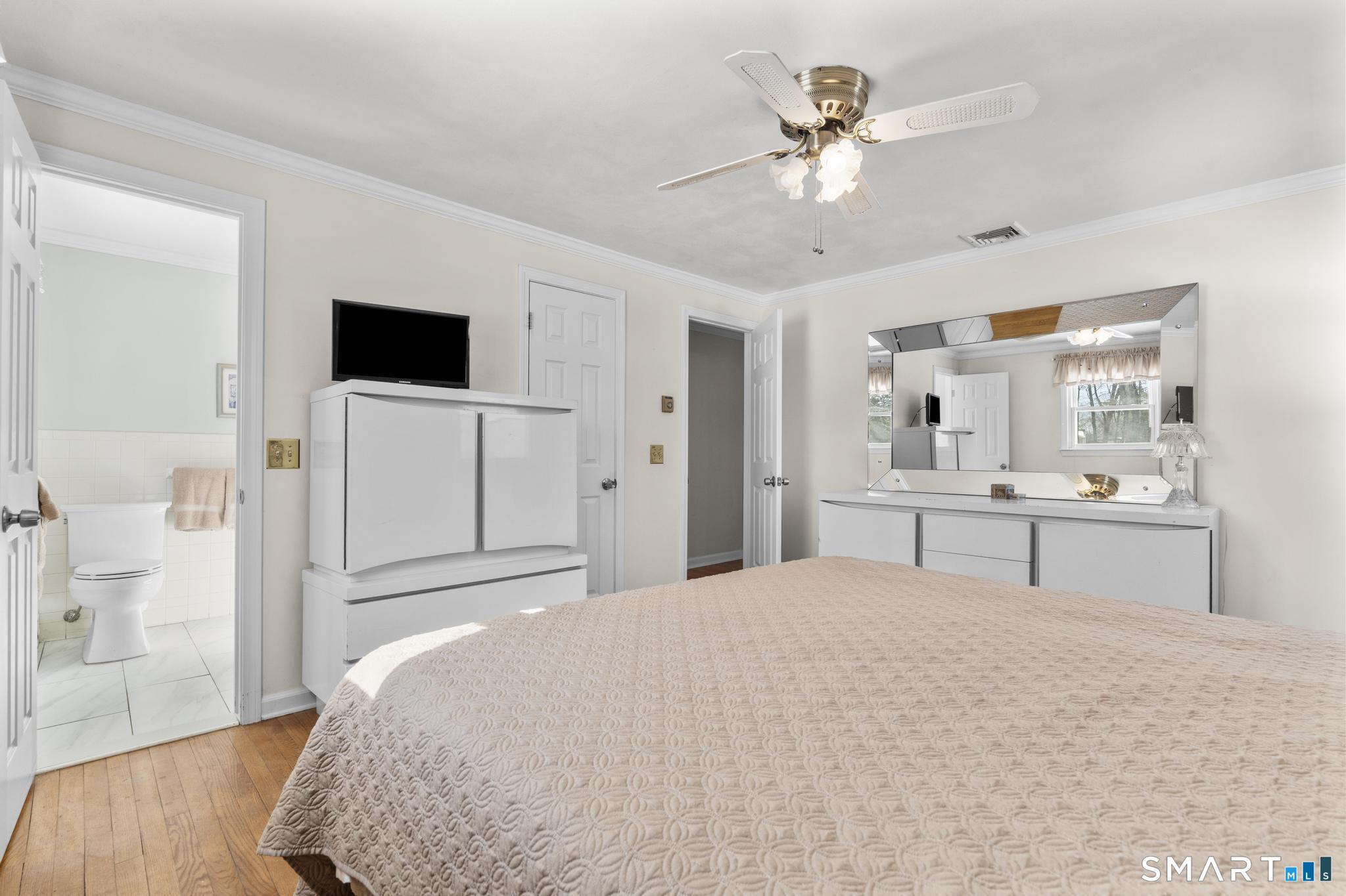 60 Quail Trail Trumbull, CT 06611 - Photo 30 of 37 a bedroom with a large bed and a flat screen tv