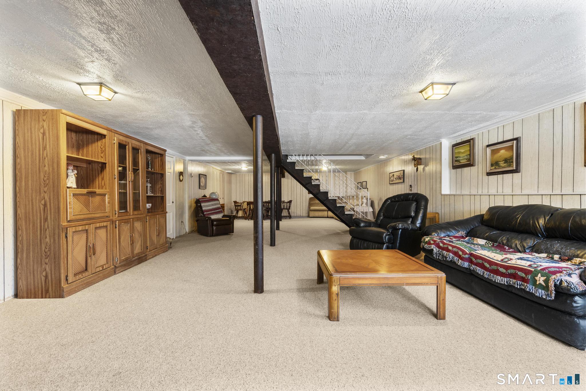 60 Quail Trail Trumbull, CT 06611 - Photo 35 of 37 a living room with furniture and a flat screen tv