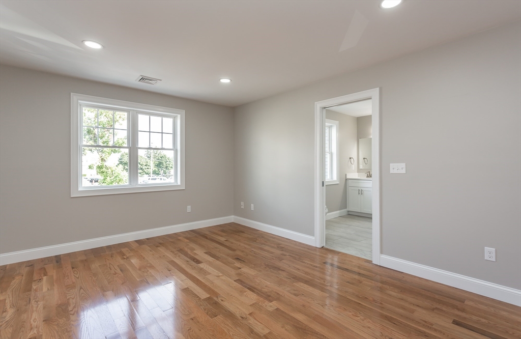 579 Summit Street, Unit 3 Fall River, MA 02724 - Photo 16 of 34 an empty room with wooden floor and windows