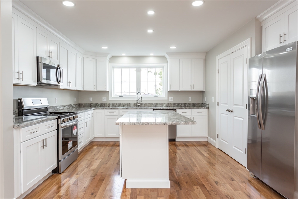 579 Summit Street, Unit 3 Fall River, MA 02724 - Photo 2 of 34 a kitchen with stainless steel appliances granite countertop a stove a sink and a refrigerator