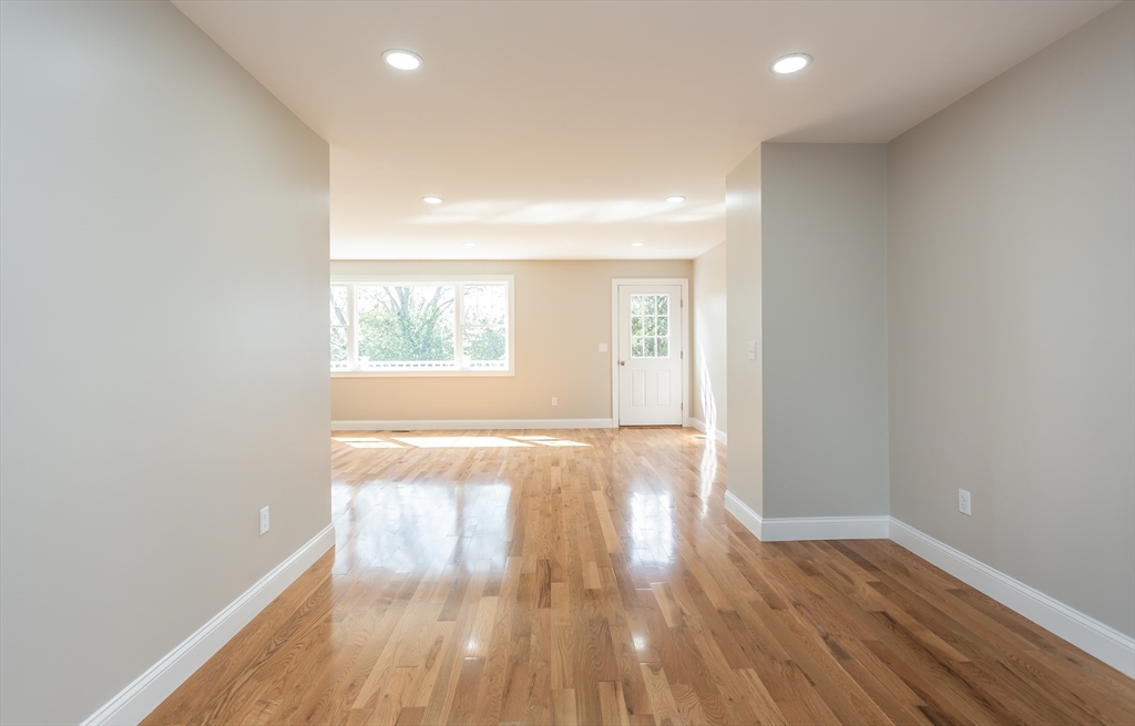 579 Summit Street, Unit 3 Fall River, MA 02724 - Photo 4 of 34 an empty room with wooden floor and windows