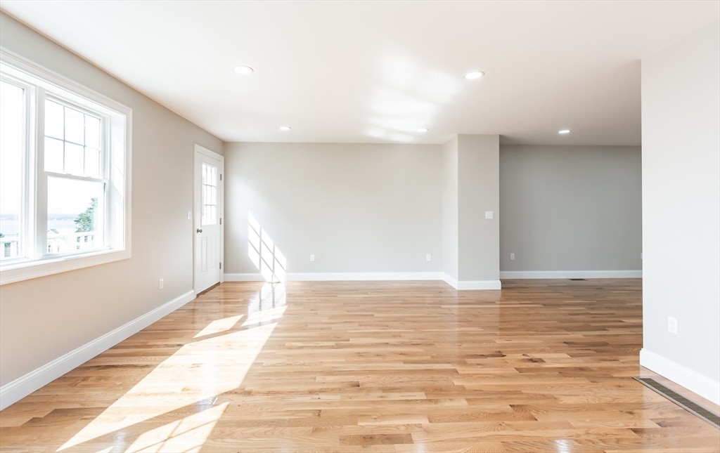579 Summit Street, Unit 3 Fall River, MA 02724 - Photo 7 of 34 a view of an empty room with window and wooden floor