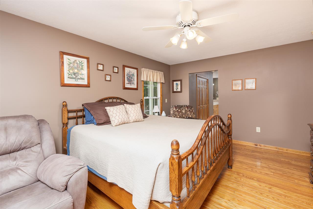875 Bailey Road Fort Defiance, VA 24437 - Photo 30 of 49 a spacious bedroom with a bed and a chandelier