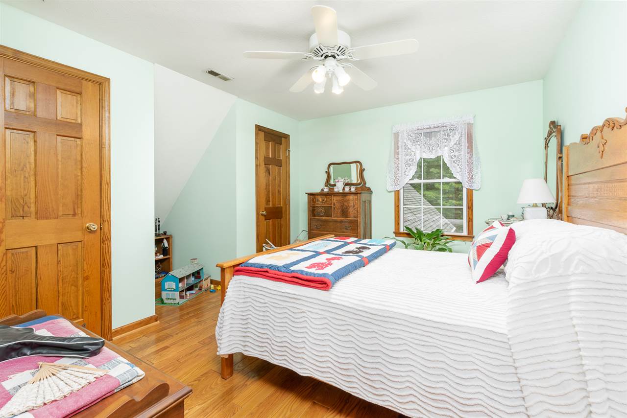 875 Bailey Road Fort Defiance, VA 24437 - Photo 37 of 49 a bedroom with a bed and a chandelier