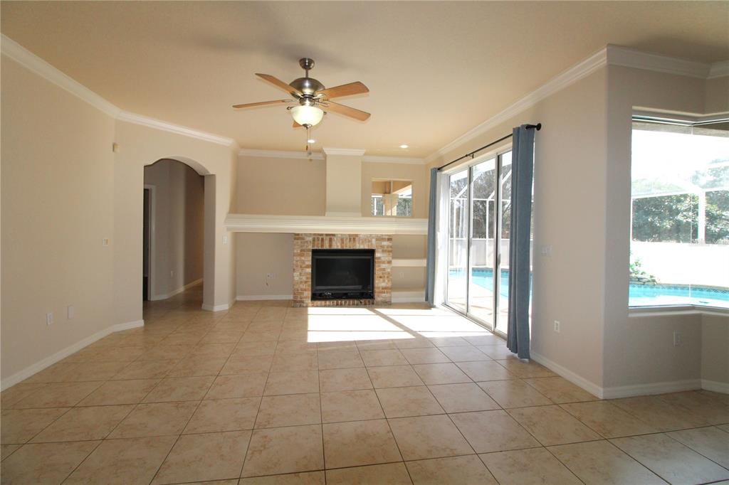 8476 Madrid Road Weeki Wachee, FL 34613 - Photo 14 of 59 a view of an empty room with a fireplace and a window