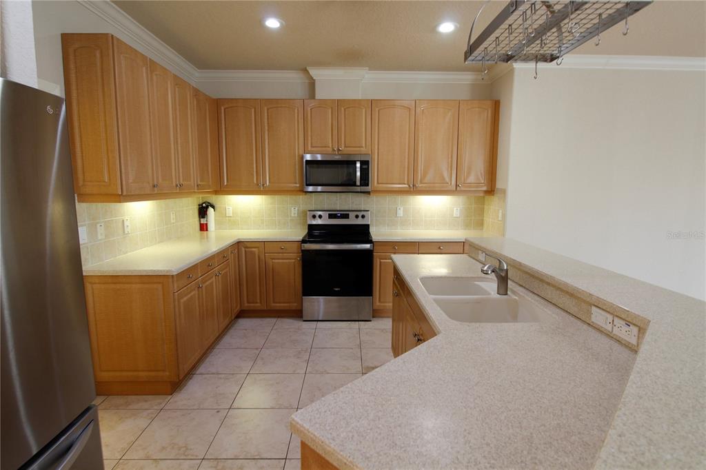 8476 Madrid Road Weeki Wachee, FL 34613 - Photo 17 of 37 a kitchen with a cabinets and steel stainless steel appliances