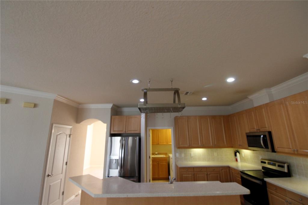 8476 Madrid Road Weeki Wachee, FL 34613 - Photo 18 of 37 a large kitchen with a large window and stainless steel appliances