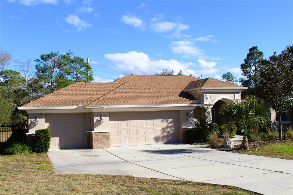 8476 Madrid Road Weeki Wachee, FL 34613 - Photo 20 of 59 a front view of a house with garden