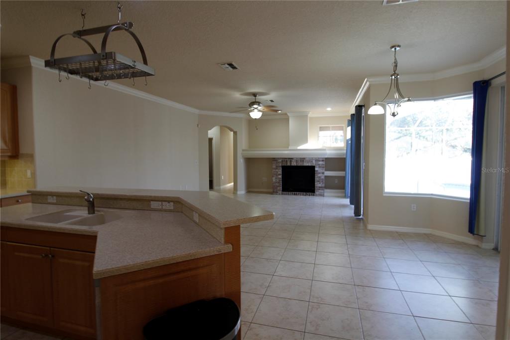 8476 Madrid Road Weeki Wachee, FL 34613 - Photo 20 of 37 a kitchen with a sink a counter top space appliances and cabinets