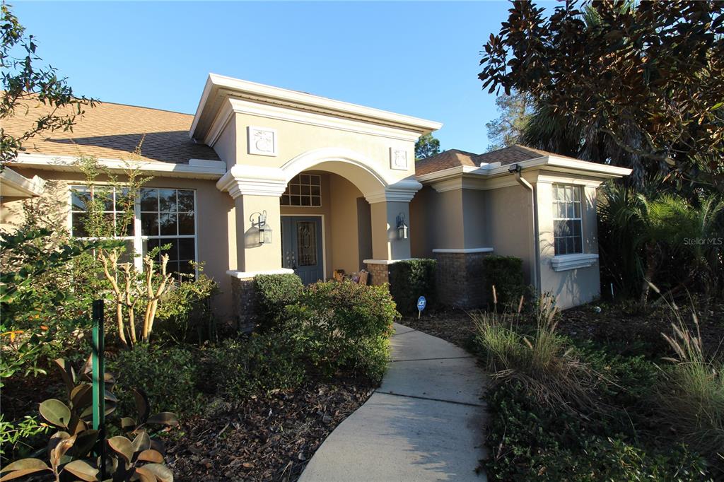 8476 Madrid Road Weeki Wachee, FL 34613 - Photo 21 of 59 a front view of a house with garden