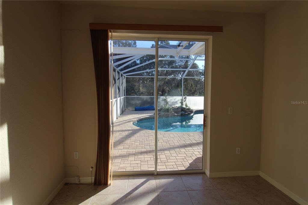 8476 Madrid Road Weeki Wachee, FL 34613 - Photo 22 of 37 a view of a glass door and a window