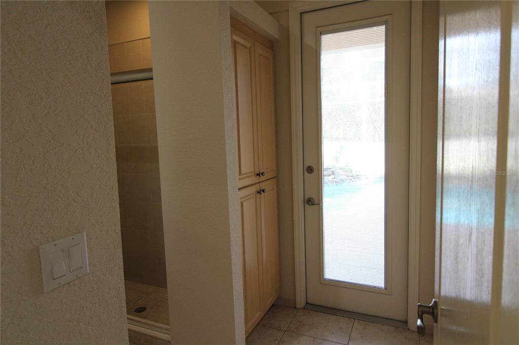 8476 Madrid Road Weeki Wachee, FL 34613 - Photo 25 of 37 a bathroom with a glass door and shower door