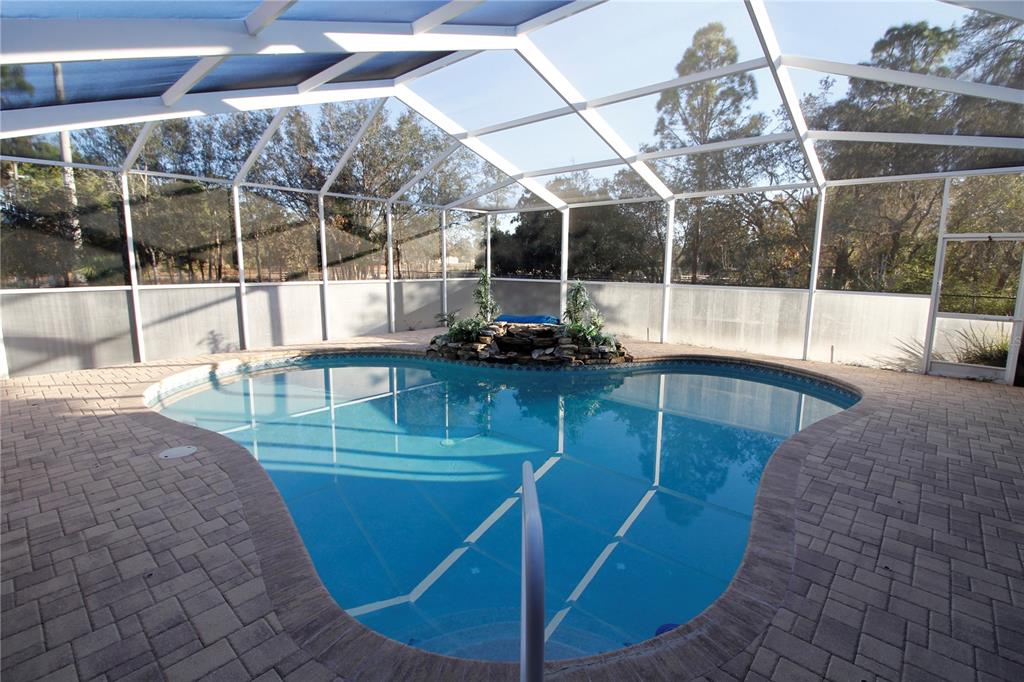 8476 Madrid Road Weeki Wachee, FL 34613 - Photo 25 of 59 a view of a swimming pool with a sitting space