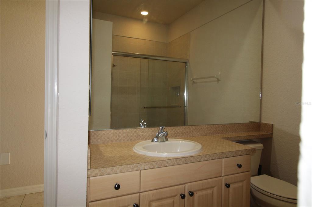 8476 Madrid Road Weeki Wachee, FL 34613 - Photo 26 of 37 a bathroom with a sink and a mirror