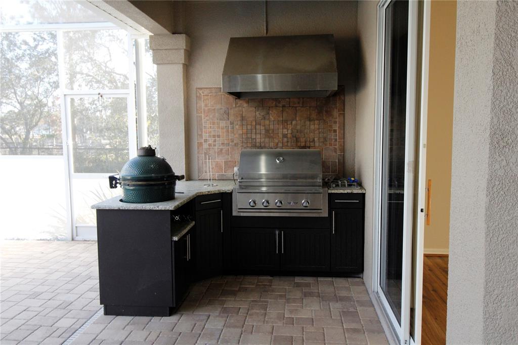 8476 Madrid Road Weeki Wachee, FL 34613 - Photo 29 of 59 a kitchen with a stove and a refrigerator