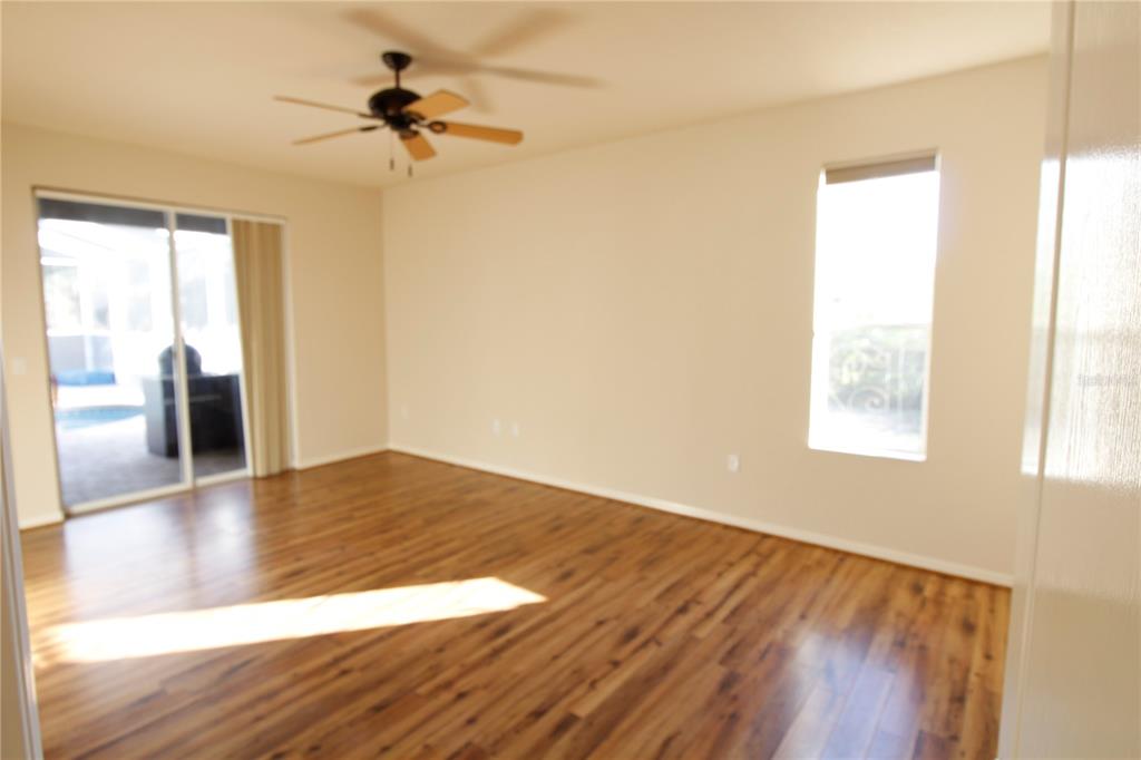 8476 Madrid Road Weeki Wachee, FL 34613 - Photo 29 of 37 a view of empty room with wooden floor and fan