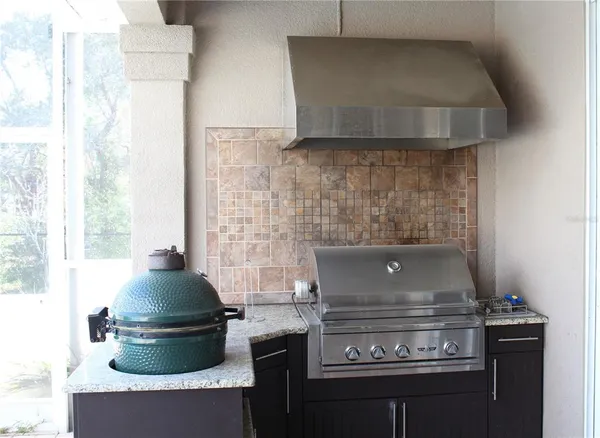a spacious bedroom with a bed a dresser and wooden floor