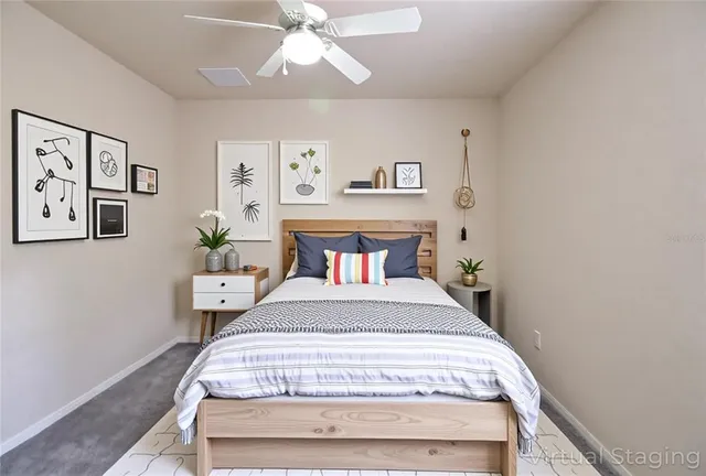 a bedroom with a bed and painting on the wall