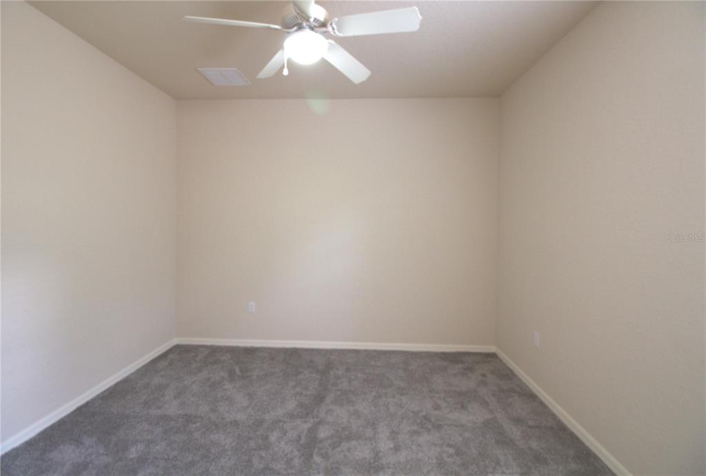 8476 Madrid Road Weeki Wachee, FL 34613 - Photo 10 of 59 an empty room with a fan & a window