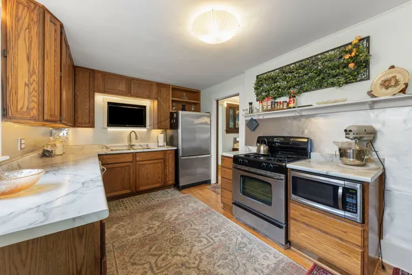 a kitchen with stainless steel appliances granite countertop a stove a sink and a refrigerator