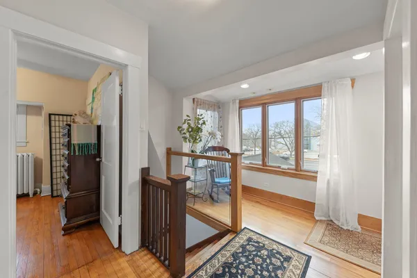 a view of a hallway with furniture and floor to ceiling window