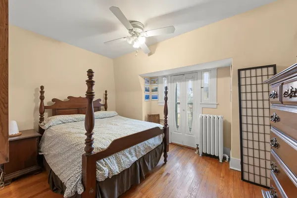 a bedroom with a bed and wooden floor
