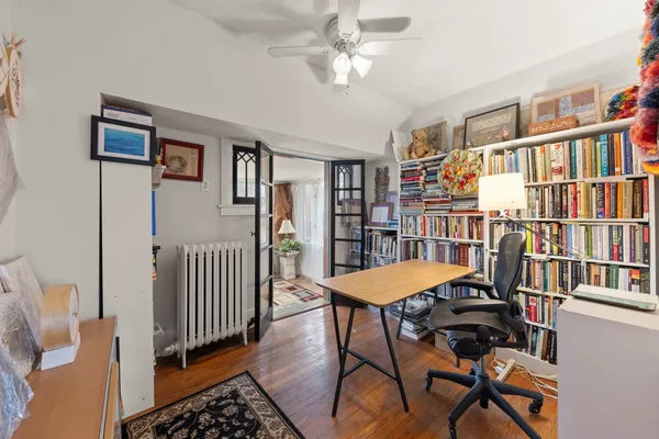 a view of a livingroom with furniture and bookshelf
