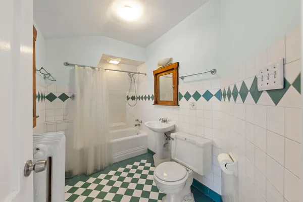 a bathroom with a toilet a sink and shower