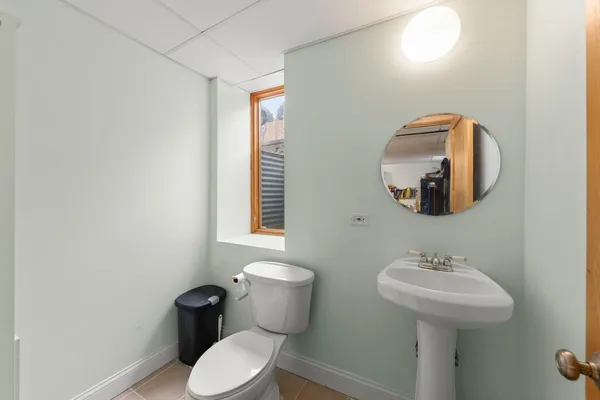 a bathroom with a toilet sink and mirror