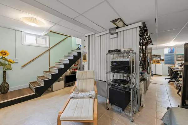 a view of hallway with stairs and furniture